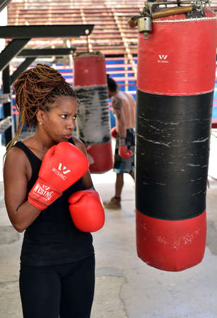 Young female boxer is training at Rafael Trejo Boxing Gym, a Cuban center to train and learnのeditorial素材
