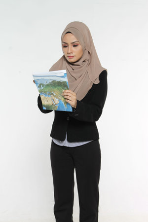 Portrait of Muslim Business woman executive reading map with face expression isolated white backgroundの写真素材