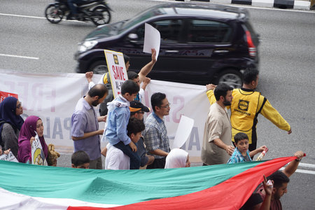 KUALA LUMPUR, MALAYSIA - 21 July 2017:Protesters gather to protest the closure of Al-Aqsa Mosque and holding banners Save Palestine "Free Al-aqsa" against Israeli Government's at Tabung Haji Buildingのeditorial素材