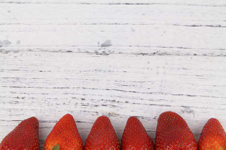 Close up row of Fresh healthy fruits Strawberries with leaves over wooden texture background. Copy Space concept. Healthy Foodの写真素材