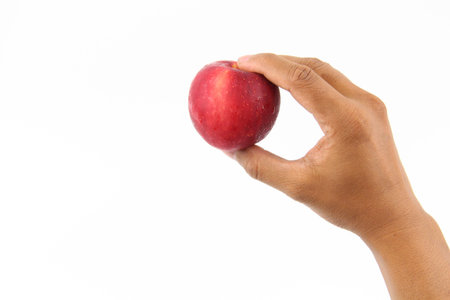 Hand holding Fresh healthy fruits apple isolated on white background. Copy Space concept. Healthy...