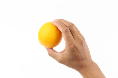Hand holding Fresh healthy fruits orange isolated on white background. Copy Space concept. Healthy...