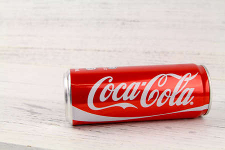 KUALA LUMPUR, MALAYSIA - 6th August 2017: A can of Coca Cola soft drinks over wooden background. Produced and manufactured by The Coca-Cola Company, an American multinational beverage corporation.のeditorial素材