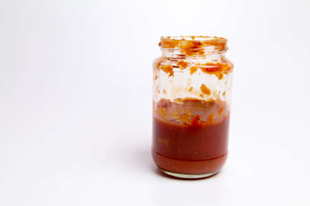 Open Glass jar with delicious homemade classic spicy tomato pasta or pizza sauce isolated white backgroundの写真素材