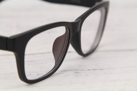 Close up Black Eye Glasses Isolated Over Wooden Background. Copy space concept