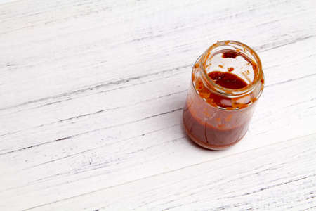Open Glass jar with delicious homemade classic spicy tomato pasta or pizza sauce over wooden texture backgroundOpen Glass jar with delicious homemade classic spicy tomato pasta or pizza sauce over wooden texture backgroundの写真素材