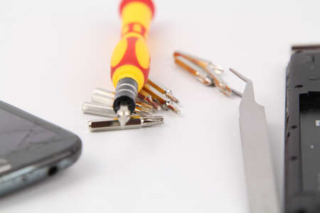 Cell phone repair. Smartphone parts and tools for recovery, selective focus.の写真素材