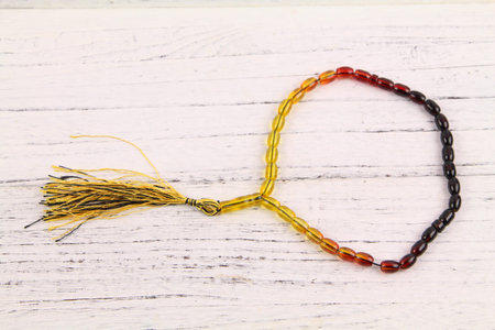 tasbih or rosary (moslem prayer beads) at wooden board
