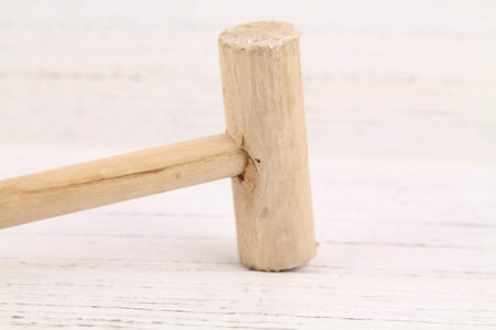 Close up Wooden hammerover wooden background