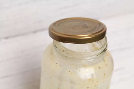 Glass Jar Carbonara Sauce in the bottles over a wooden background texture. Selective focusの写真素材