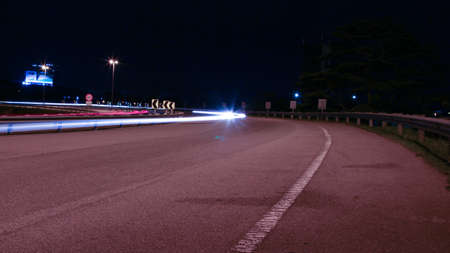 Speed Traffic - light trails on motorway highway at night, long exposure abstract urban backgroundの写真素材