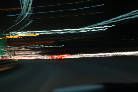 Abstract light trails on motorway highway at night, long exposure shake image