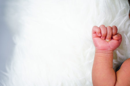 Close up new born baby sleeping on furry cloth. Parenting concept. Motherhood