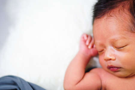 Close up new born baby sleeping on furry cloth. Parenting concept. Motherhoodの写真素材