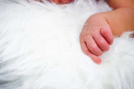 Close up new born baby sleeping on furry cloth. Parenting concept. Motherhoodの写真素材