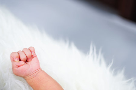 Close up new born baby sleeping on furry cloth. Parenting concept. Motherhood