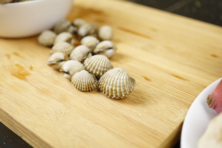 Close up Cockles Shells seafood on a table. Prepareration Cooking Concept