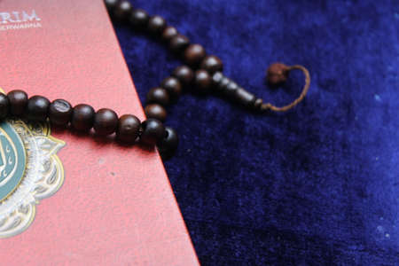 Close up Holy Quran with tasbih or muslim beads rosery over a praying mat. Ramadan Kareemの写真素材