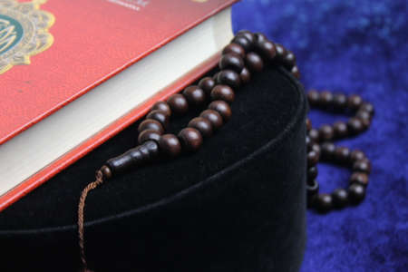 Close up Holy Quran with tasbih or muslim beads rosery over a praying mat. Ramadan Kareemの写真素材