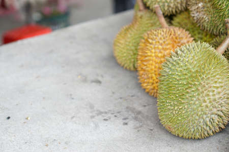 Closeup fresh exotic tropical fruits Durian for sale at an outdoor market. Organic fruits on street market. Fruit season. Durian is king of fruit is famous Asian fruit.の写真素材
