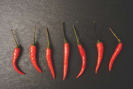 Chillies on slate, stone grunge texture. Vintage tone. Food Copy Spaceの写真素材