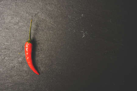 Chillies on slate, stone grunge texture. Vintage tone. Food Copy Spaceの写真素材