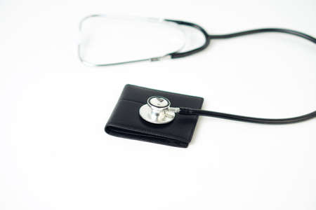 Diagnose finance situation with stethoscope and cash walletの写真素材