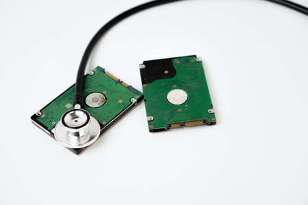 An hard disk with a sthetoscope isolated on white background. Recovery and Data Safetyの写真素材