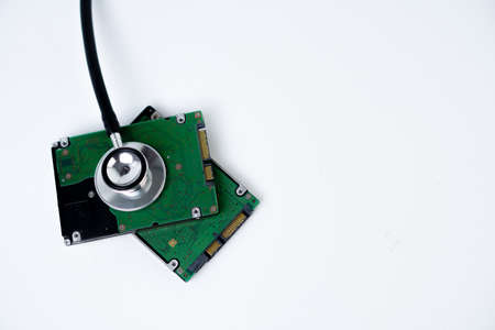 An hard disk with a sthetoscope isolated on white background. Recovery and Data Safetyの写真素材