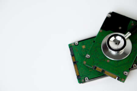 An hard disk with a sthetoscope isolated on white background. Recovery and Data Safetyの写真素材