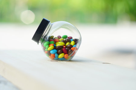Colorful Candies Chocolate inside a jar over wooden backgroundの写真素材