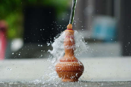 Water pour on the Traditional Malay hand made Clay pottery arts for water storage container or Labu Sayong or Labu Sayungの写真素材