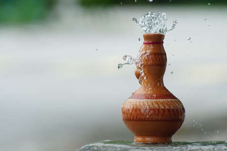 Water pour on the Traditional Malay hand made Clay pottery arts for water storage container or Labu Sayong or Labu Sayungの写真素材