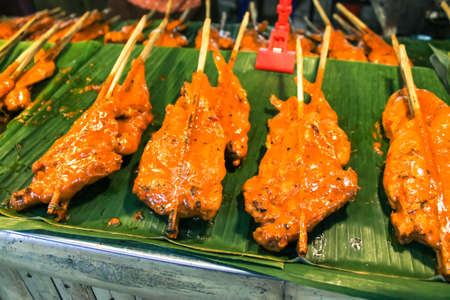 A delicious spicy barbecued marinated chicken on a local market stall. Malaysian dish food, also known as "ayam percik". Asian Street food.の写真素材