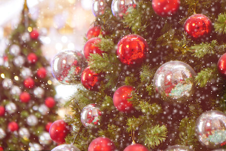 Close up Christmas tree decorated with silver and red Christmas balls. Snow Effect Soft Focus. Copy...