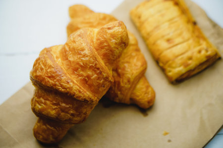 two fresh croissants on white background