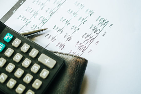 Close up a calculator over yellow background. Financial Calculation Concept.