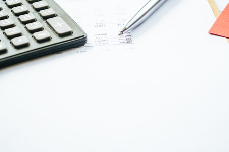 Close up a calculator over yellow background. Financial Calculation Concept.の写真素材