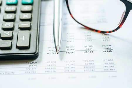 Close up a calculator over yellow background. Financial Calculation Concept.の写真素材