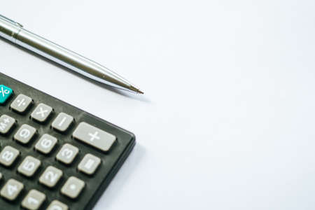 Financial calculation numbers chart with pen, calculator, glass, and notes. Selective Focusの写真素材