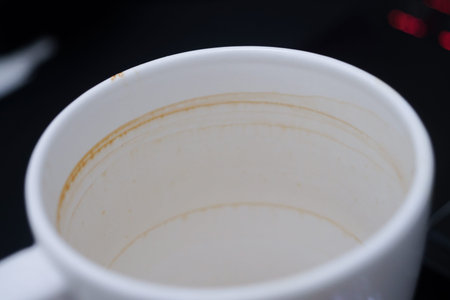 Close up Empty white cup with coffee stain over black backgroundの写真素材