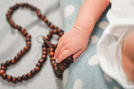 Infant Baby hand holding a muslim beads rosery or tasbihの写真素材