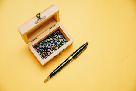 A black pen and wooden chest treasure box with letters alphabet inside. Education Concept