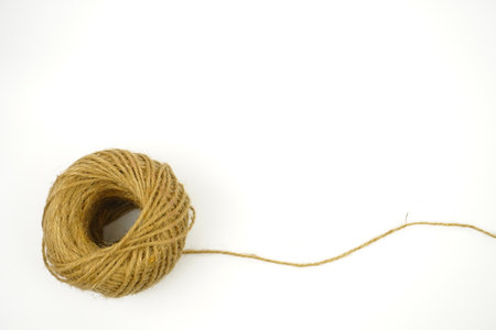 Ball of Wool. A skein of linen string, cord isolated. Coil of twine. Jute rope. Hemp thread isolated.の写真素材