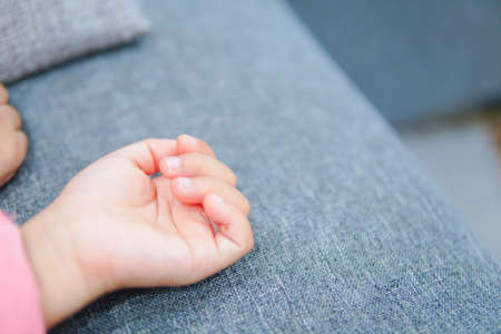 Cute little girl kids tolder hand close up while sleeping. Selective focusの写真素材