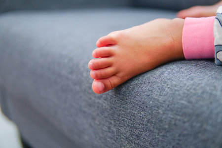 Cute little girl kids tolder feet close up while sleeping. Selective focusの写真素材