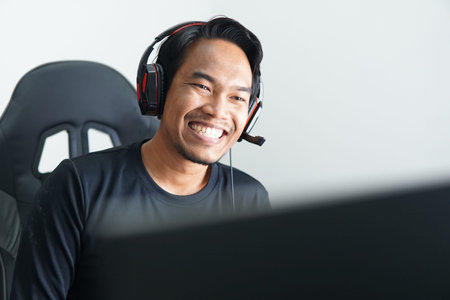 Front view head shot smiling mixed race man freelancer wearing headset, communicating with client...