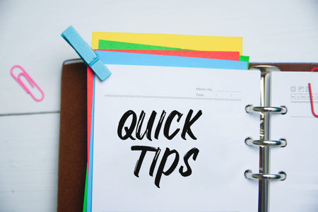 QUICK TIPS word on a notebook. Top view Flat lay conceptual