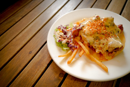 Delicious food on a plate with french fries and salad.