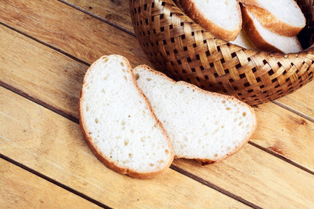Two slices of bread near wicker breadbasket